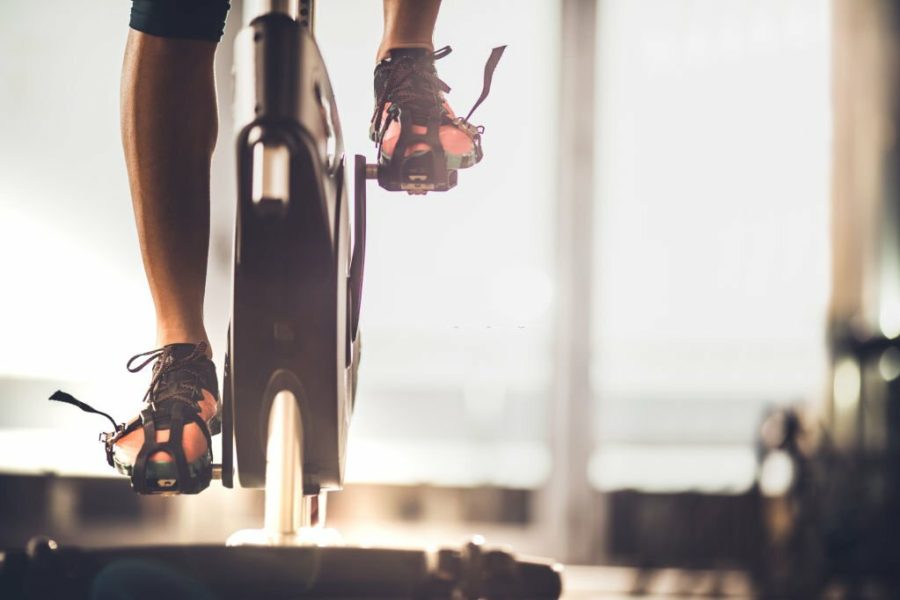 Unrecognizable athletic legs during exercising training in a health club.